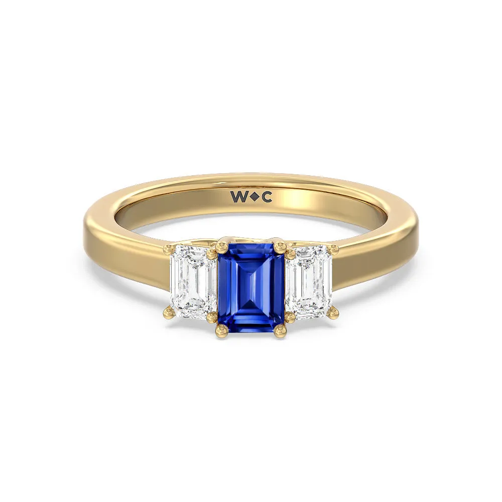 Created Sapphire Center And Emerald Cut Three Stone Diamond Ring