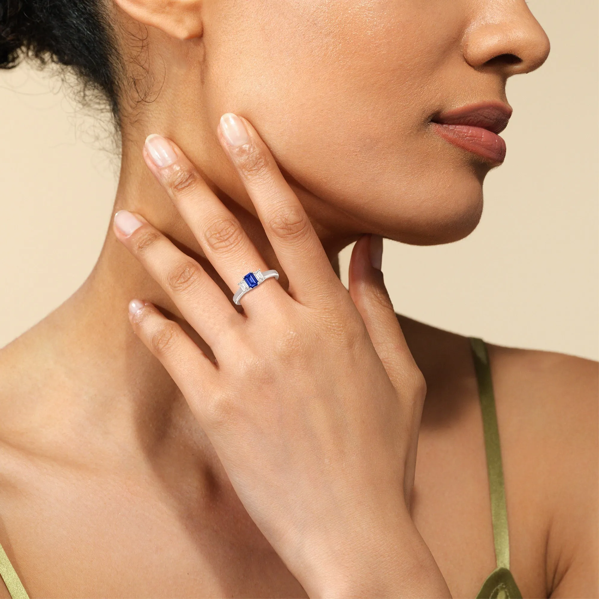 Created Sapphire Center And Emerald Cut Three Stone Diamond Ring