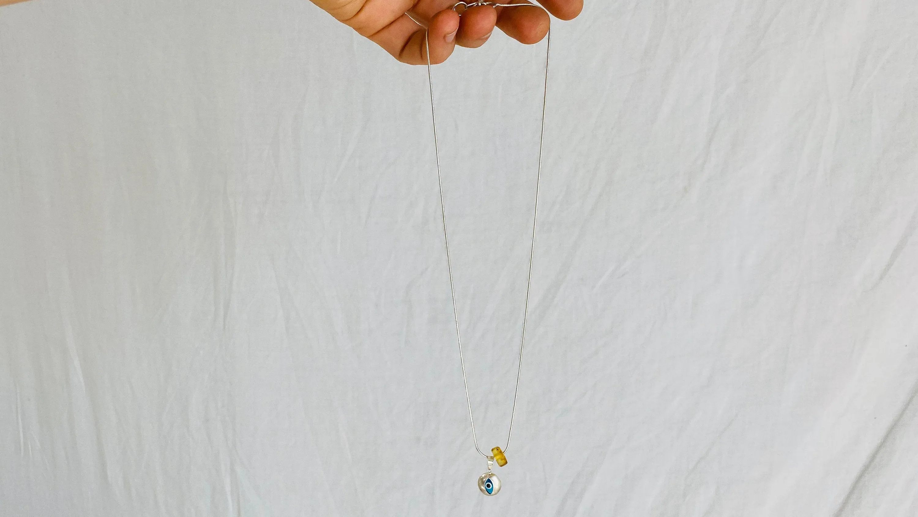 Evil Eye Pendant. Sterling Silver and Amber.